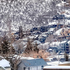 Square frame Park City Utah mountain in winter with colorful homes that sit on snowy slopes