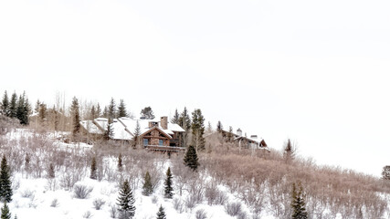 Panorama Mountain top in Park City Utah with homes that sit amid snowy slope in winter
