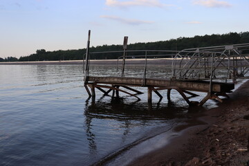 lake pier with metal railing in the morning