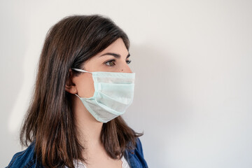 Young woman wearing medical protective mask