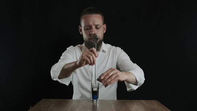 Preparing of Lexus Cocktail. Bartender pouring irish cream into glass