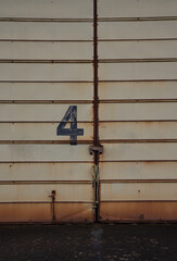 Rusted, locked, steel doors marked with the number 4