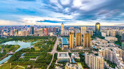 China Hainan Haikou Cityscape in the Binhai Avenue CBD Area, with Landmark Buildings , Sea Port and Evergreen Park View During Sunset. Aerial View..