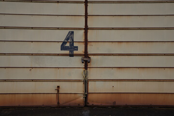 Rusted, locked, steel doors marked with the number 4