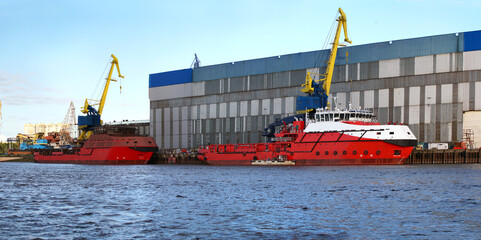 Two red rescue vessels are standing near the Marina