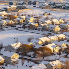 Square crop Aerial view of homes in snowy Utah Valley neighborhood at sunset in winter