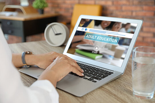 Woman using laptop for online studying indoors, closeup. Adult education