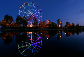 Colorfull abstract Ferris wheel with reflection on the Konny island in Irkutsk city