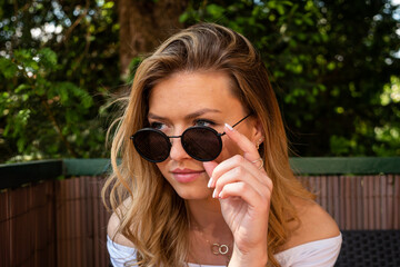 Naklejka premium Pretty Blond Woman with Sunglasses Looking Away
