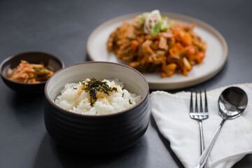 rice topped with sesame and seaweed with korean food
