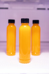 Bottle of orange juice in refrigerator get ready for summer.