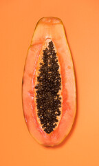 Half papaya with a plain background