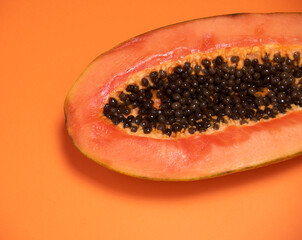 Orange background with the detail of a papaya