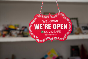 Welcome we are open sign in front of a shop after covid-19 pandemic 