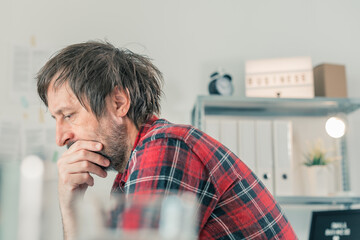 Troubled freelancer thinking in home office