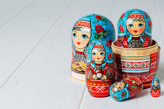 Five red matryoshka. Traditional Russian toy. Copy space. White wooden background
