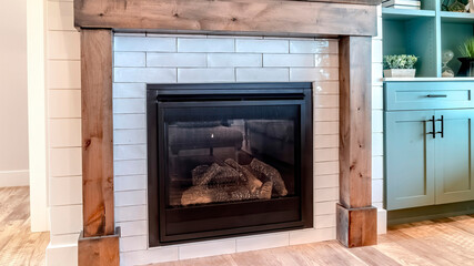 Panorama crop Interior of living room with fireplace and fitted display and storage cabinet