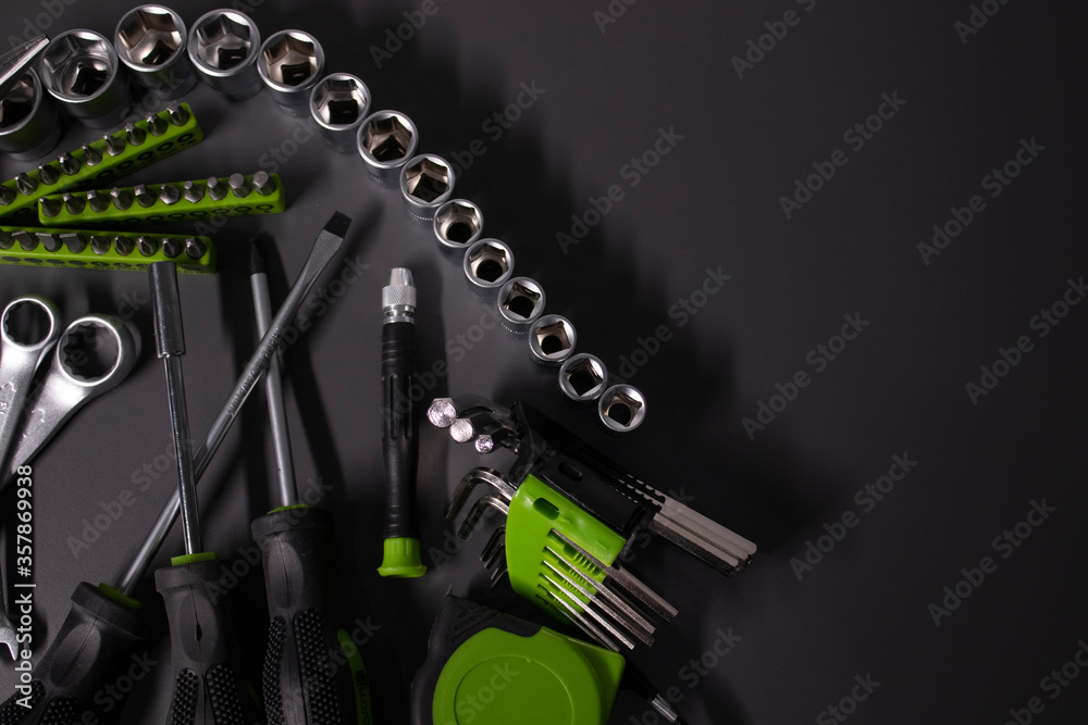 Wall mural a set of building tools and instruments for repair in black and green colour. must-have for men. equ