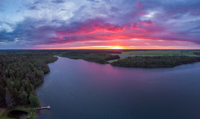 Fototapeta premium Magical purple sunset over lake in Belarus. Drone aerial photo
