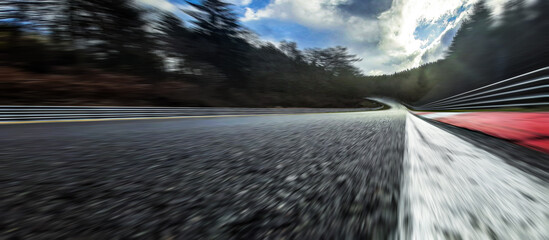 Race Car / motorcycle racetrack after rain on a cloudy mixed weather day.