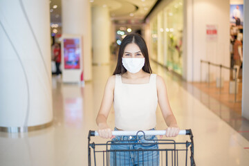 portrait of beautiful woman is wearing face mask in shopping center