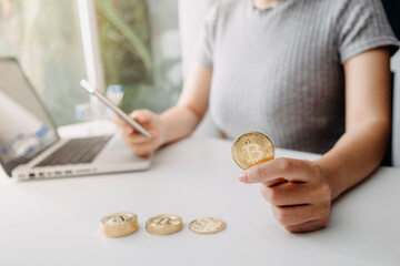 Fototapeta premium businesswoman holding coins putting in glass with using smartphone and calculator to calculate concept saving money for finance accounting