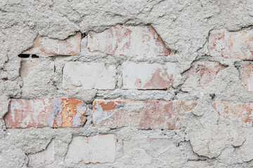 texture and background of the big old brick under the plaster.