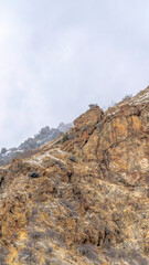 Vertical crop Snow dusted terrain of the rocky Prvo Canyon in Utah with cloudy sky background