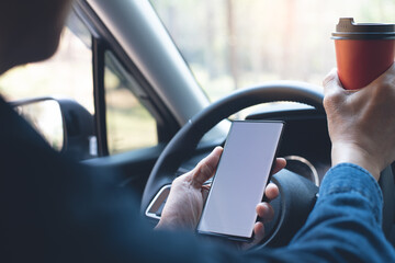 Mockup man using mobile phone and drinking coffee while driving  a car