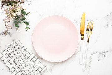 Table Setting Empty Pink Plate, Textile, Flowers And Golden Cutlery. Top View Copy Space