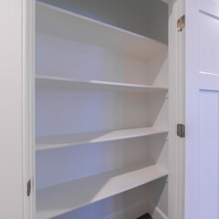 Square crop Empty white wooden shelves in a cupboard