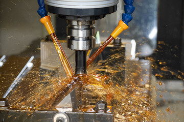 The CNC milling machine cutting the tire mold parts with liquid oil coolant method. The mold and...
