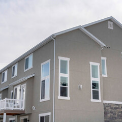 Square Townhouses exterior with small balconies at the facade in South Jordan Utah