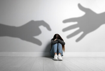Scared teenage girl suffering from sciophobia and phantoms behind her. Irrational fear of shadows
