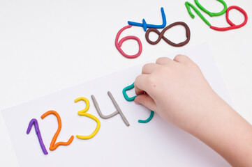 Colorful digits made from plasticine. Bright colored volumetric figures for children (isolated on white)