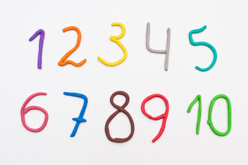 Colorful digits made from plasticine. Bright colored volumetric figures for children (isolated on white)