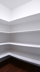 Vertical crop Empty white fitted shelves in an interior room