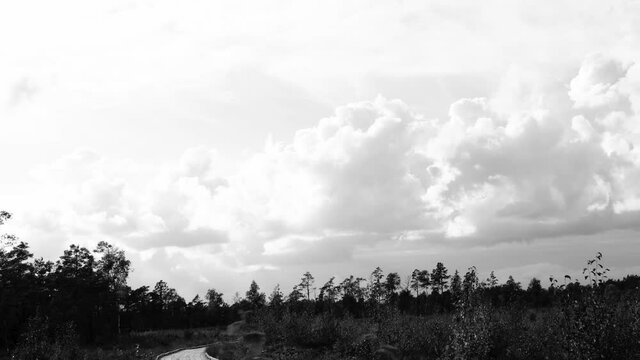 Feeling of an old vintage movie in black and white. Timelapse of clouds on a bog. Filter Sl Noir 1965.