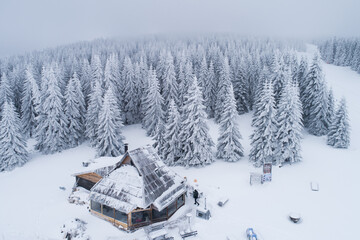 Drone view of a mountain villa covered in snow after blizzard