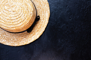 Fototapeta na wymiar Hipster straw hat with a black ribbon. Summer mood.