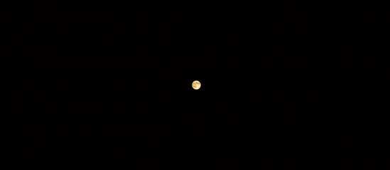 Full moon in the black sky. Mysterious photo.