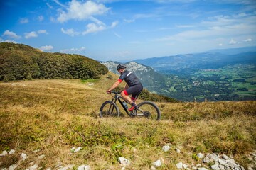 Male mountain biker on Nanos plateau in Slovenia on a sunny day