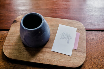Empty post it and Japanese tea cup on red wood background.
