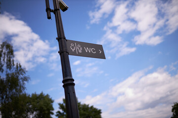 Toilet sign in the park.