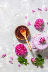 Fototapeta na wymiar Homemade tea rose petal jam on a light table with copy space.Top view