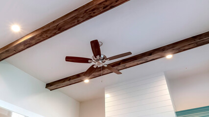 Panorama frame Wood beams and recessed bulbs with ceiling fan and lights at the center