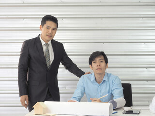 Portarit of asian businessman and architect or engineer in office.