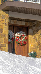Vertical frame Double door decorated with wreath at the entrance of home in Wasatch Mountains