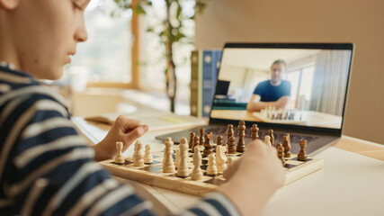 Brilliant Little Boy Playing Chess with His Distant Relative or Uncle, Uses Laptop for Video Call....