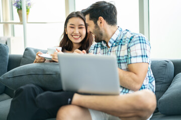 Happy young couple working on laptop at home or modern office with copy space.startup family business or work from home concept.